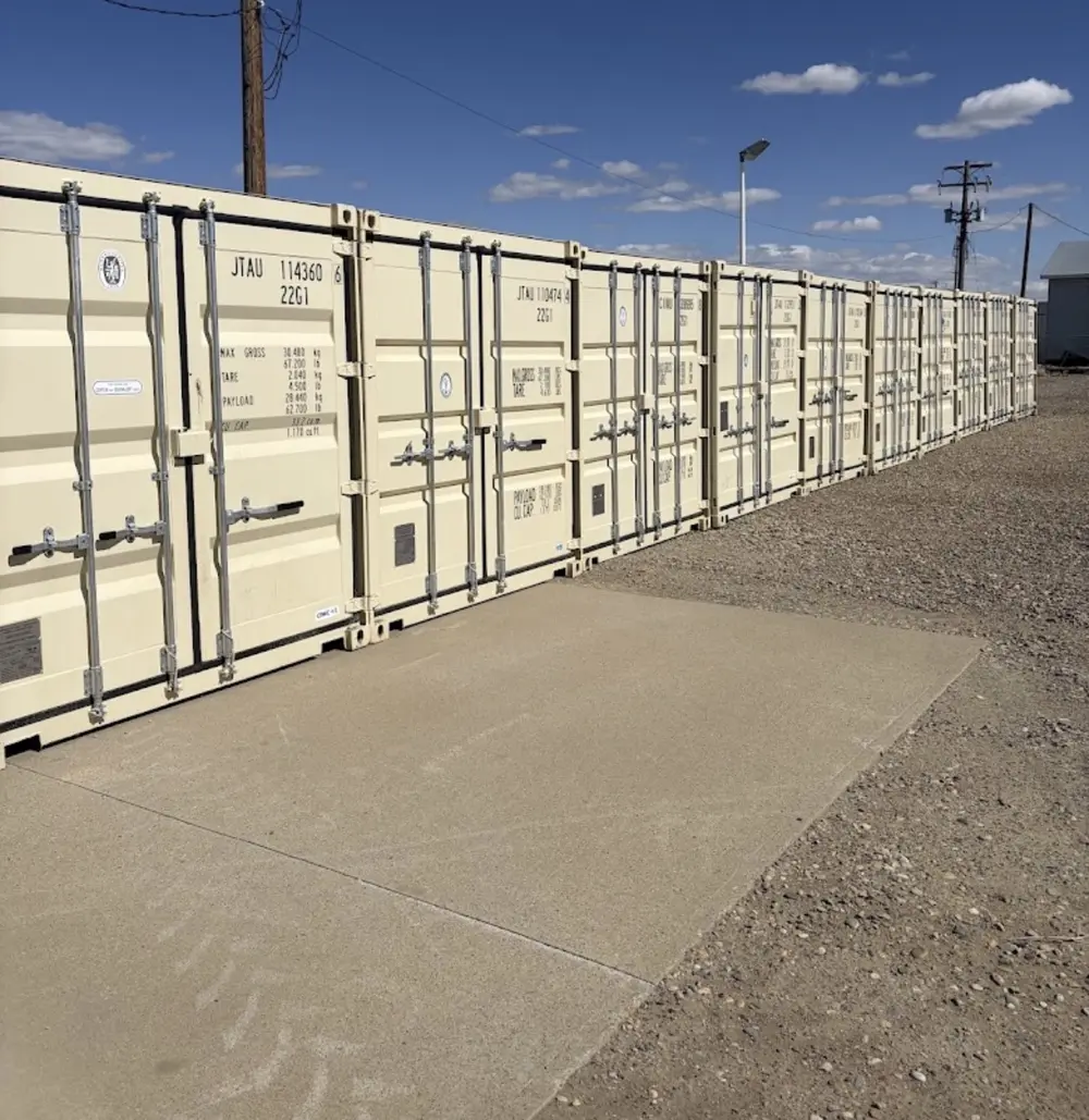 Actual Vault 4 Storage cream sea cans with silver door bars beside the gravel lot
